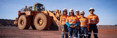 Team in front of dozer