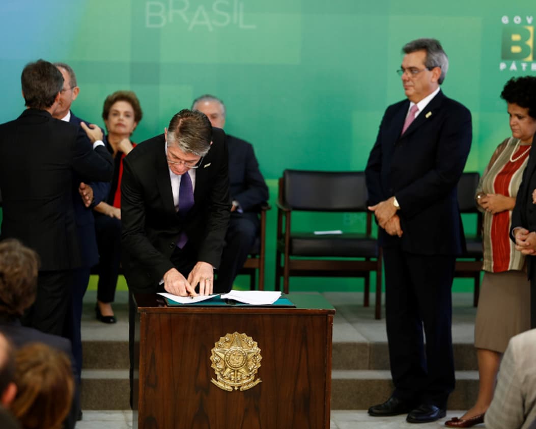 people signing at a signing ceremony